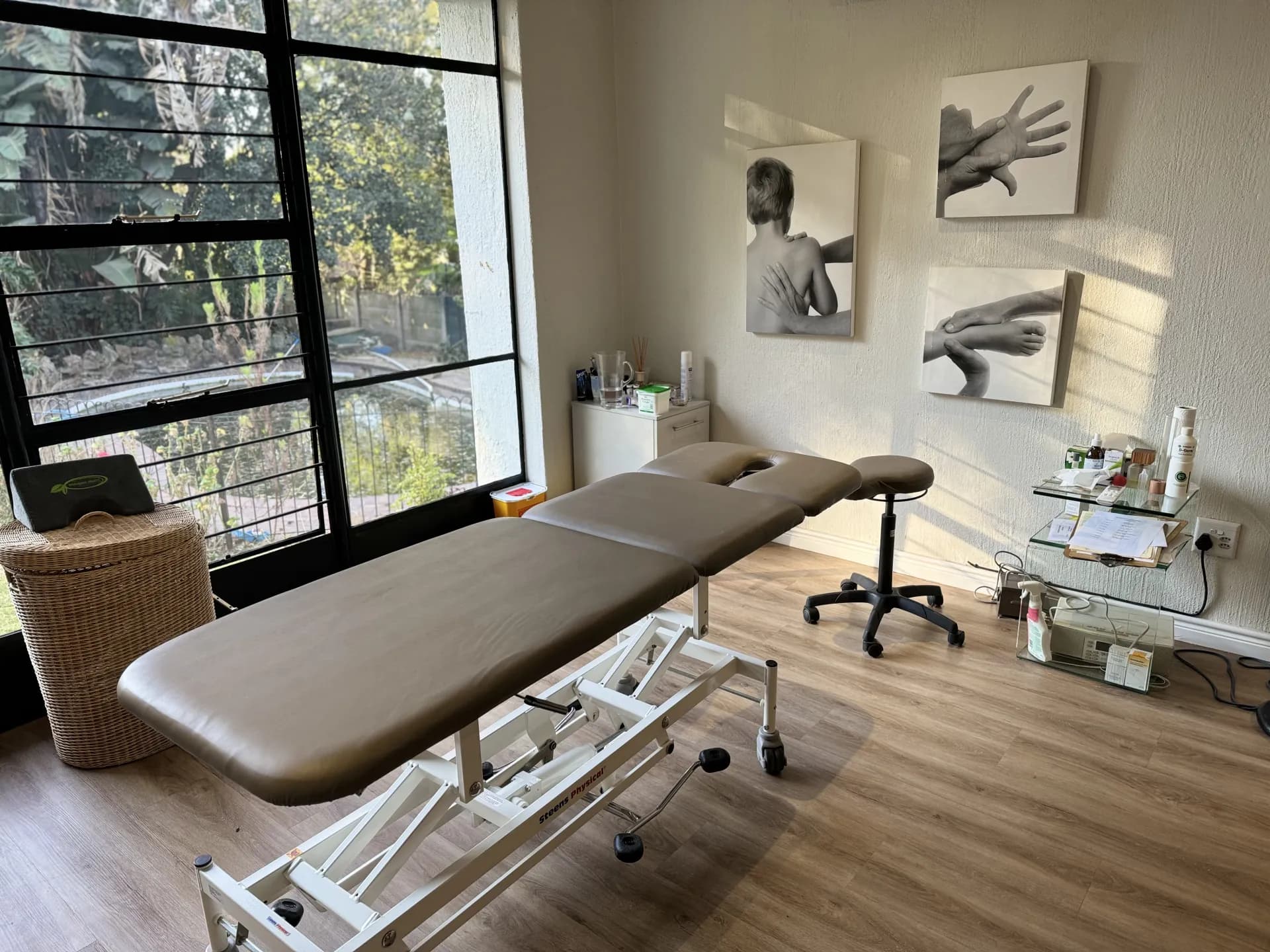 Peaceful massage therapy room with professional treatment table, soft lighting, and calming spa atmosphere